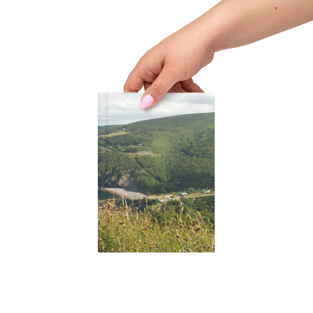 Hand holding the Nova Scotia coastal photography hardcover journal for scale